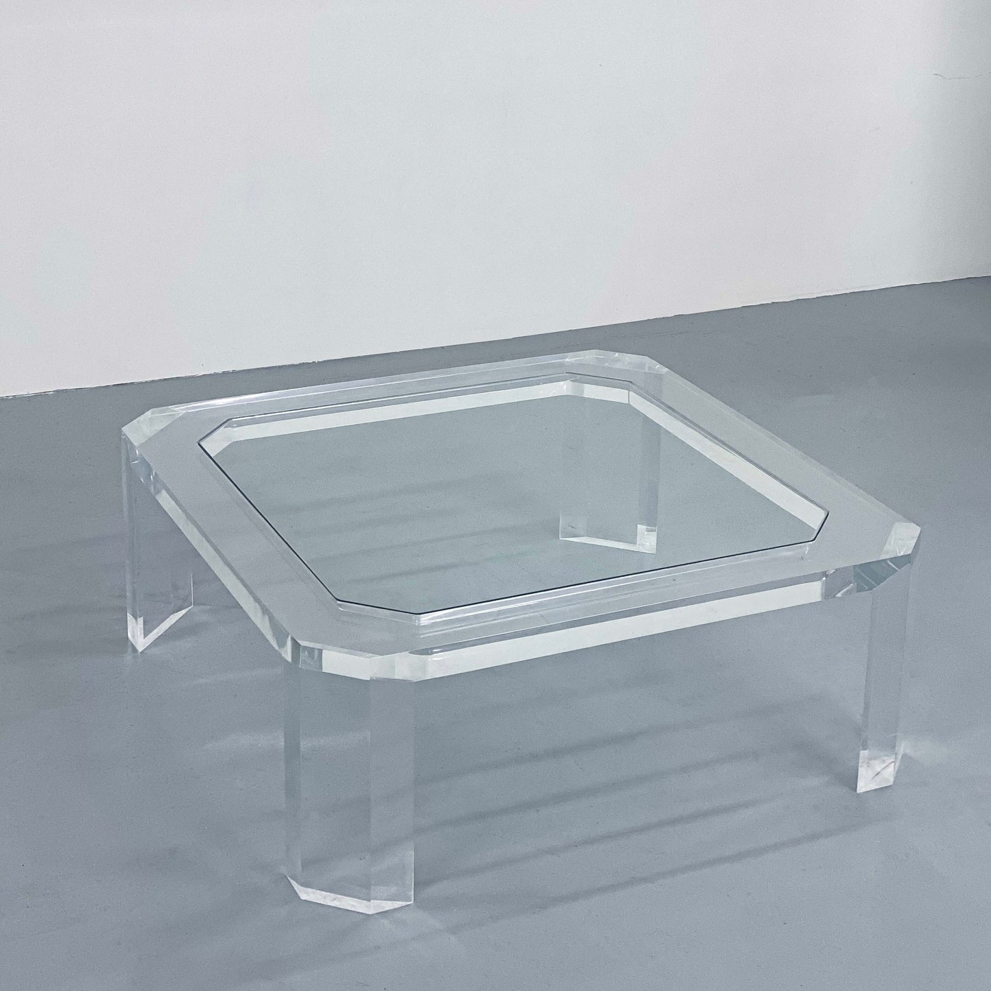 a clear glass coffee table on a gray floor in Portland Oregon