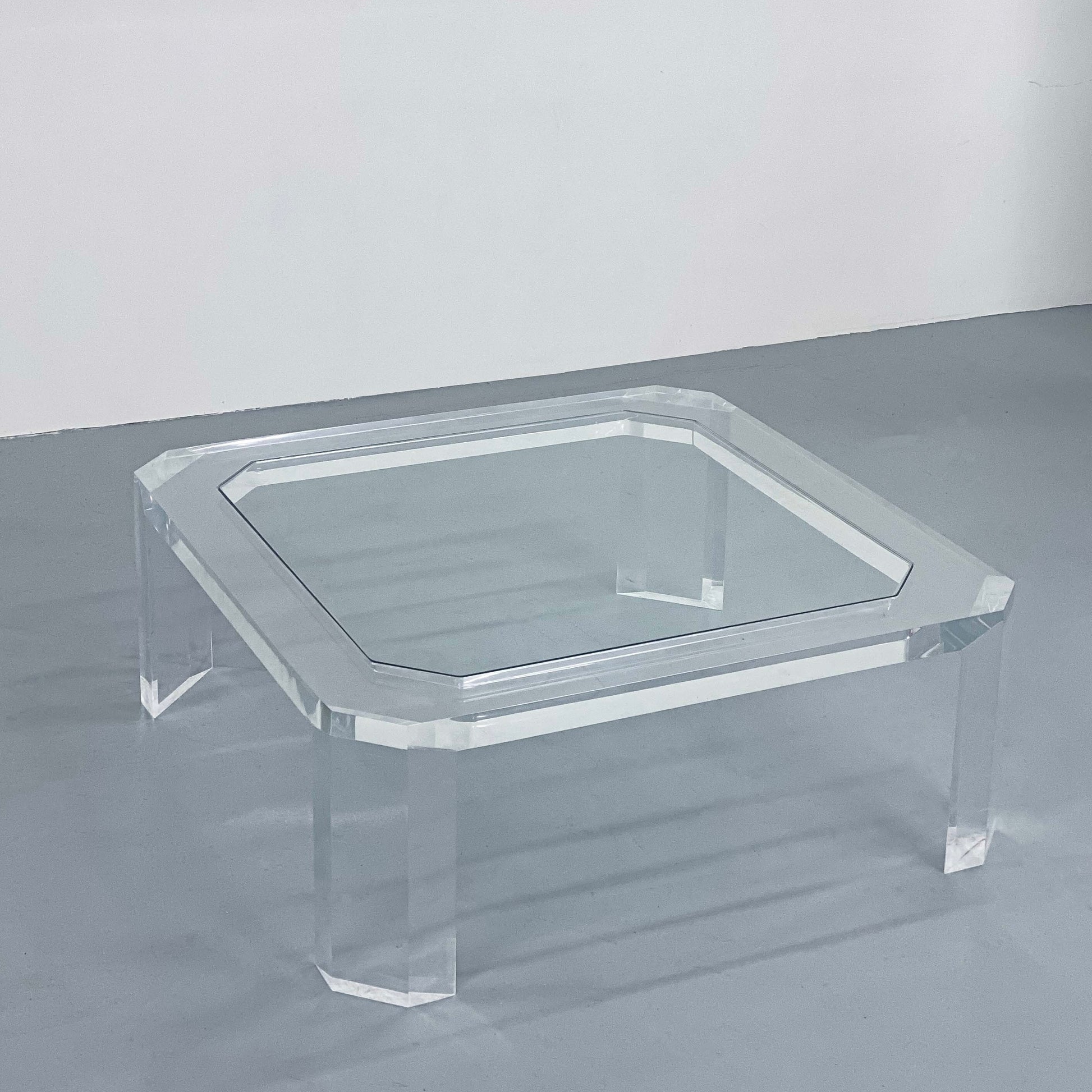 a clear glass coffee table on a gray floor in Portland Oregon