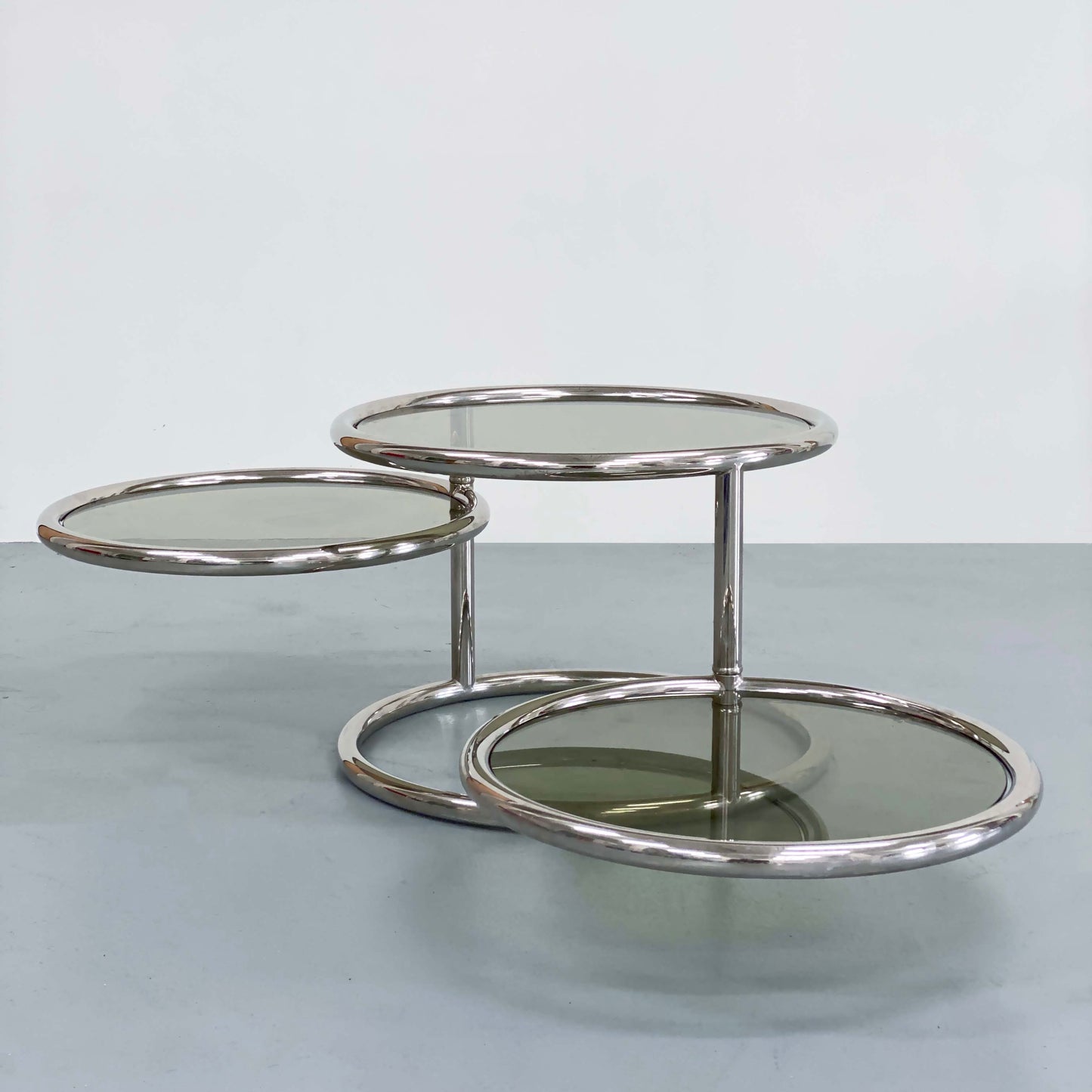 ITALIAN SMOKED GLASS AND CHROME SWIVEL COFFEE TABLE