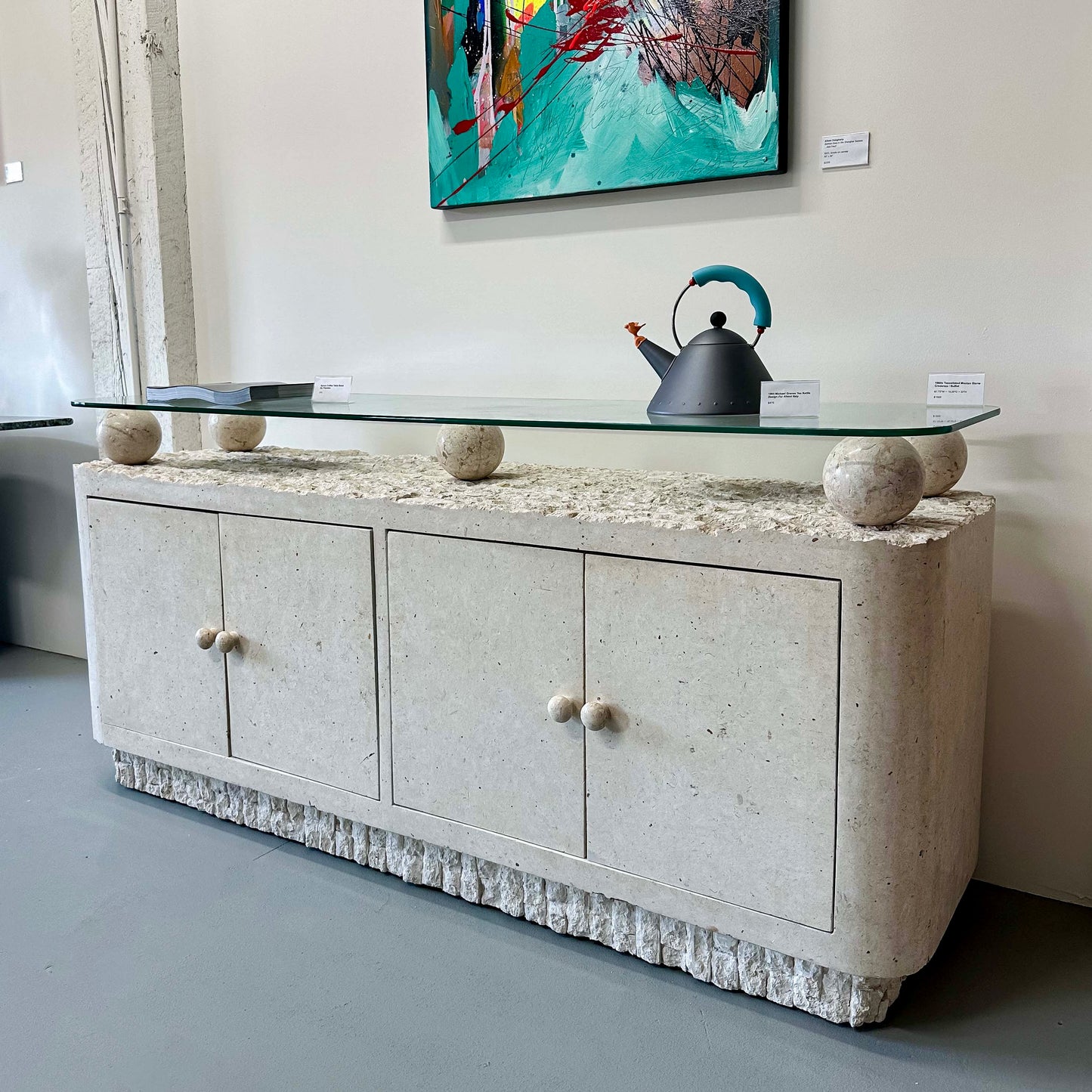 TESSELLATED MACTAN STONE AND GLASS TOP CREDENZA