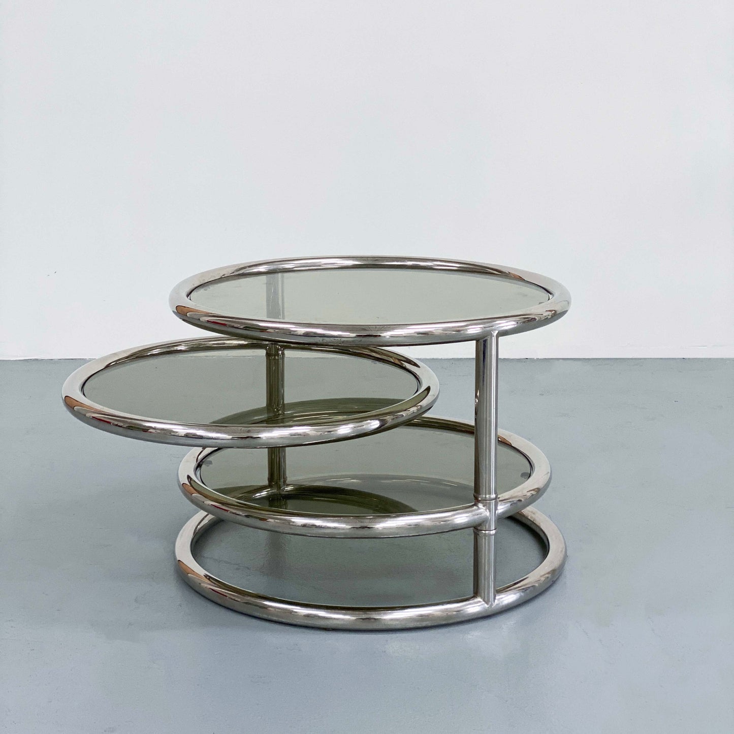 ITALIAN SMOKED GLASS AND CHROME SWIVEL COFFEE TABLE